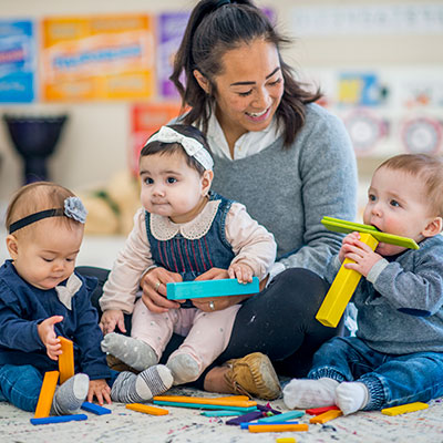 Female teacher playing with toddlers